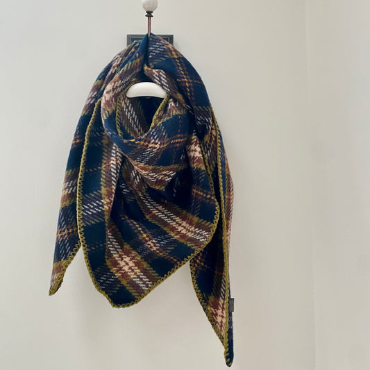      Navy tartan pattern thick scarf     Triangular shaped      Blanket stitched edge detail in khaki     Super soft feel     80% Acrylic 20% Wool     Measures 37" (at longest width point) x 37" (at honest depth point)     Also available in Red