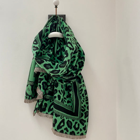 GREEN LEOPARD PRINT PATTERN WOMENS SCARF      Black and Green Leopard print scarf     Super soft fabric     Border print detail      Frayed ends     Measures 70" long x 27" wide     80% Viscose 20% Wool     Also available in Navy and Pink