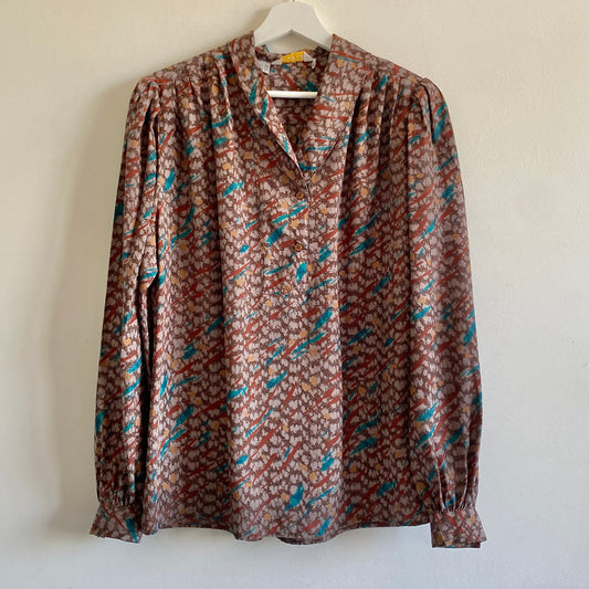 80s brown patterned vintage blouse Shawl collar Full sleeves with single button cuff Gathering to front and back yoke 100% Polyester Machine washable 
