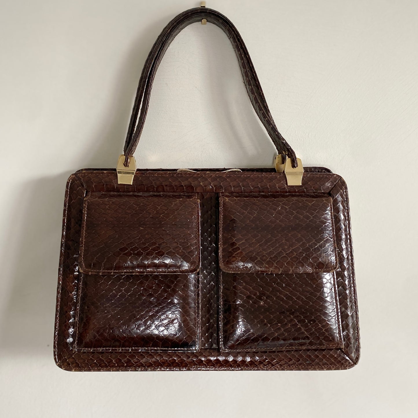 Late 70s Vintage brown leather snake skin bag Top handles Two front pockets Three internal pocket Clasp fastening Internal zip pocket and open pocket Gold colour hardware Fully lined