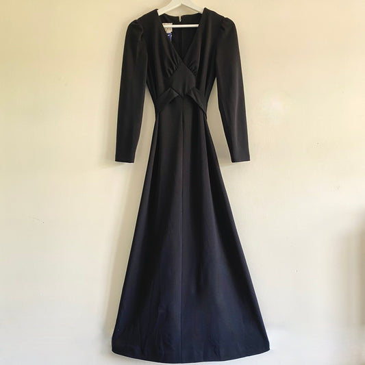 Black vintage 70s evening dress By Allegro V neckline with diamond shape detail Long sleeves Light gathering to bust with tie  A line shape Fastens at back with concealed zip 100% Polyester