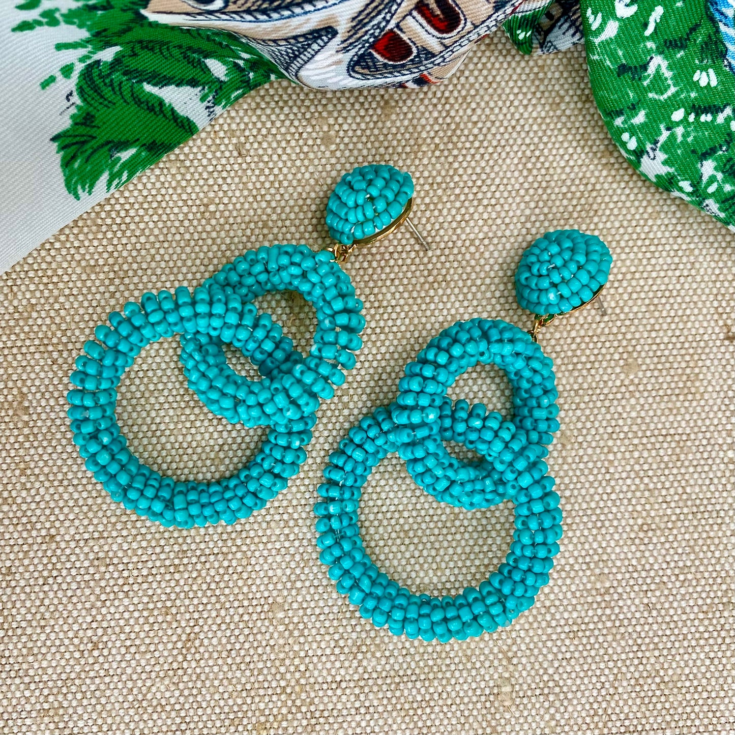      Turquoise beaded statement earrings     Intertwined hoop design     Post and stud back fastening     Drop 8cm     FREE UK SHIPPING