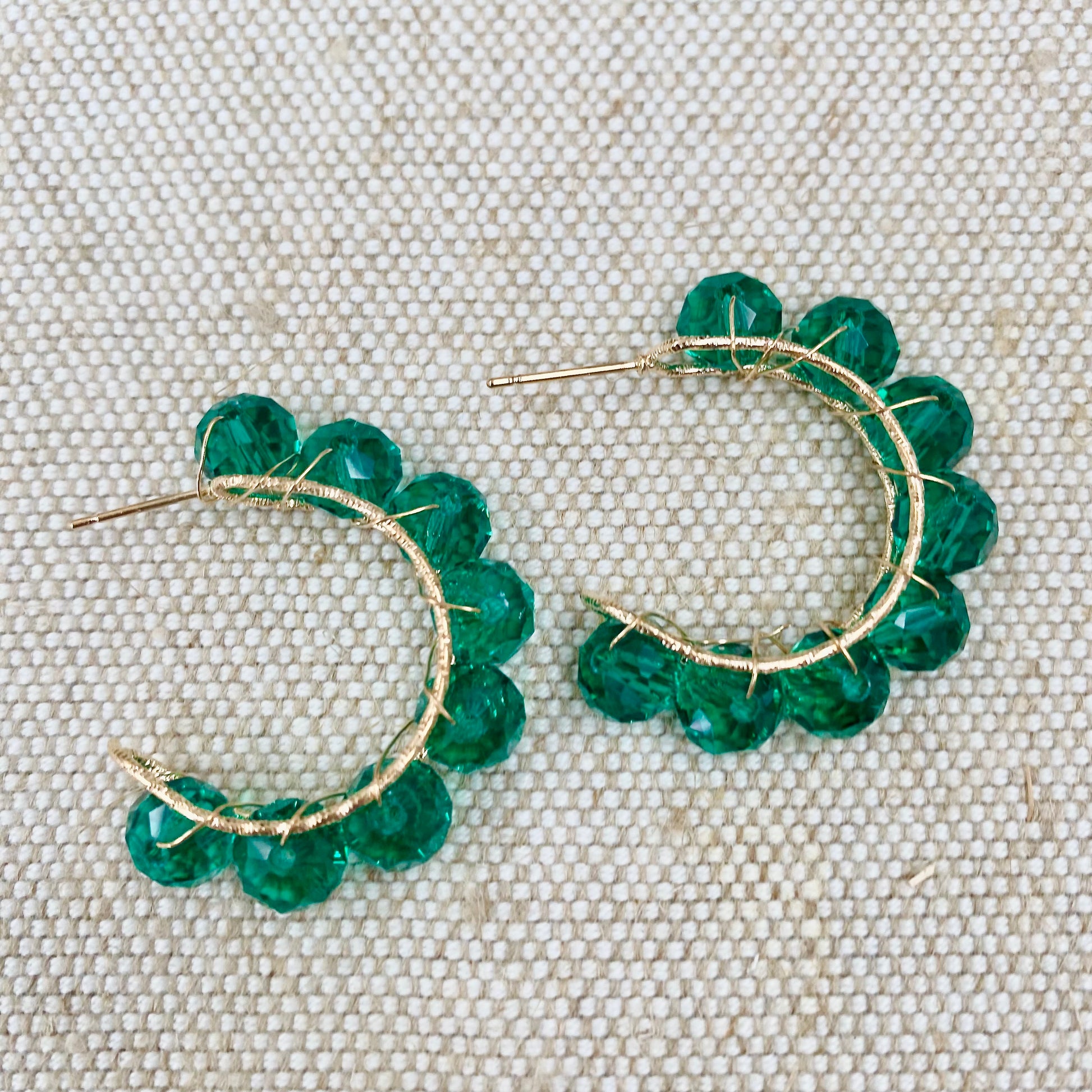      Gold tone hoops with wrapped wire bead detailing     Post and stud back fastening     Drop 3cm     Available in Blue, Green, Red and Gold     FREE UK SHIPPING