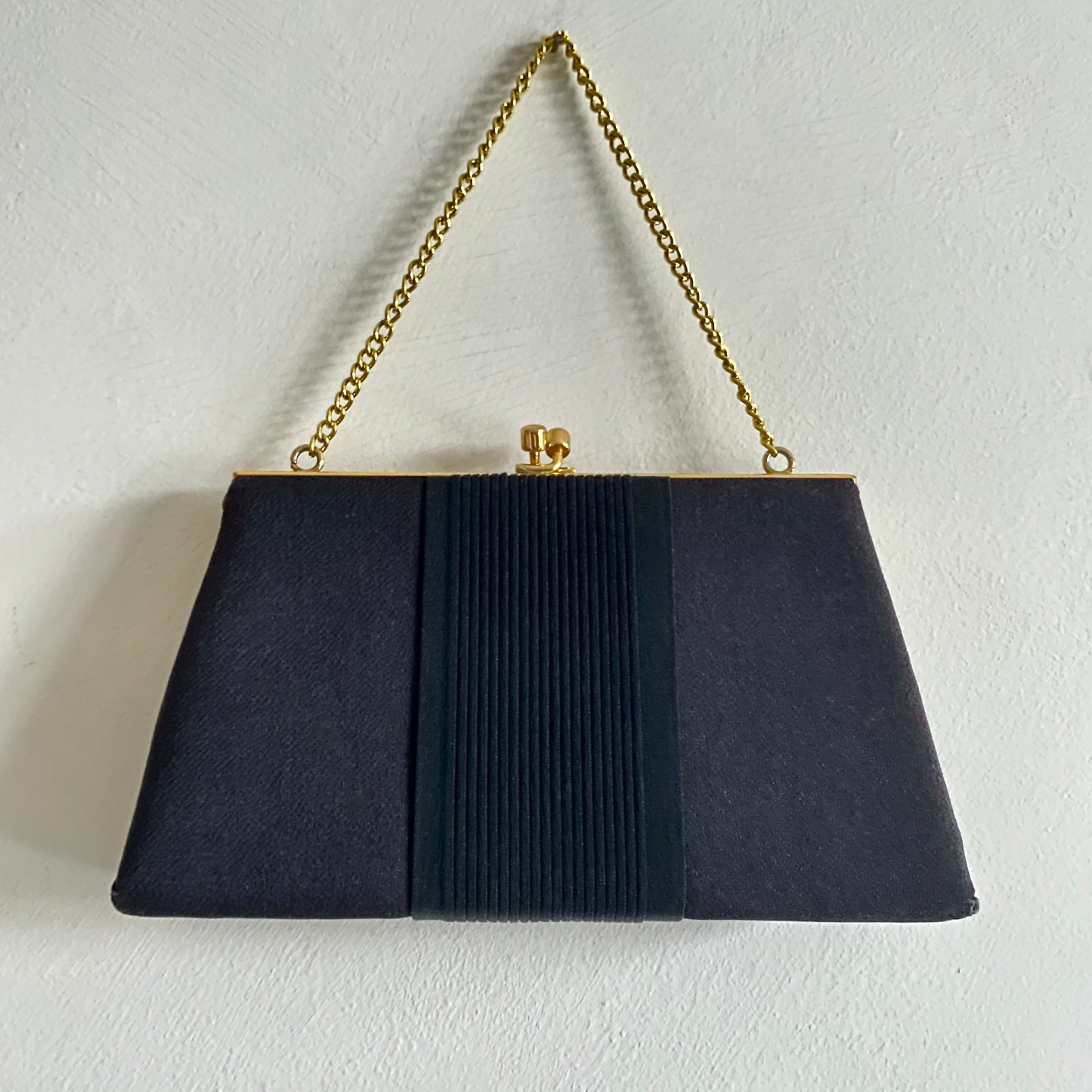 Black grosgrain vintage evening bag Gold clasp closure Gold chain handle (12") Fabric lined Measures 9" wide x 5" high x 2"